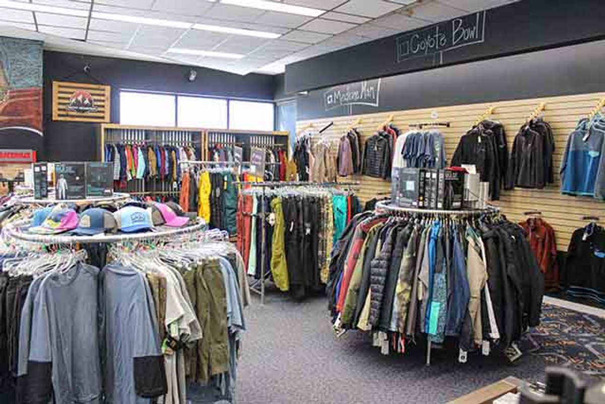 Clothing Racks with racks and having clothing racks on the slat wall.