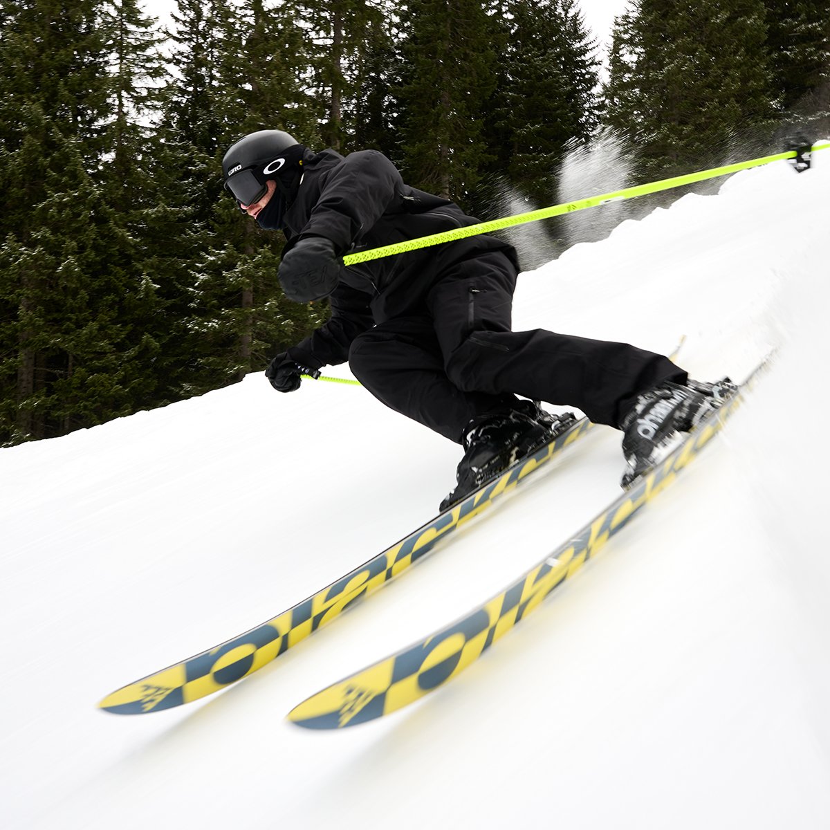 Skiier on Black Crow skis carving down a slope.