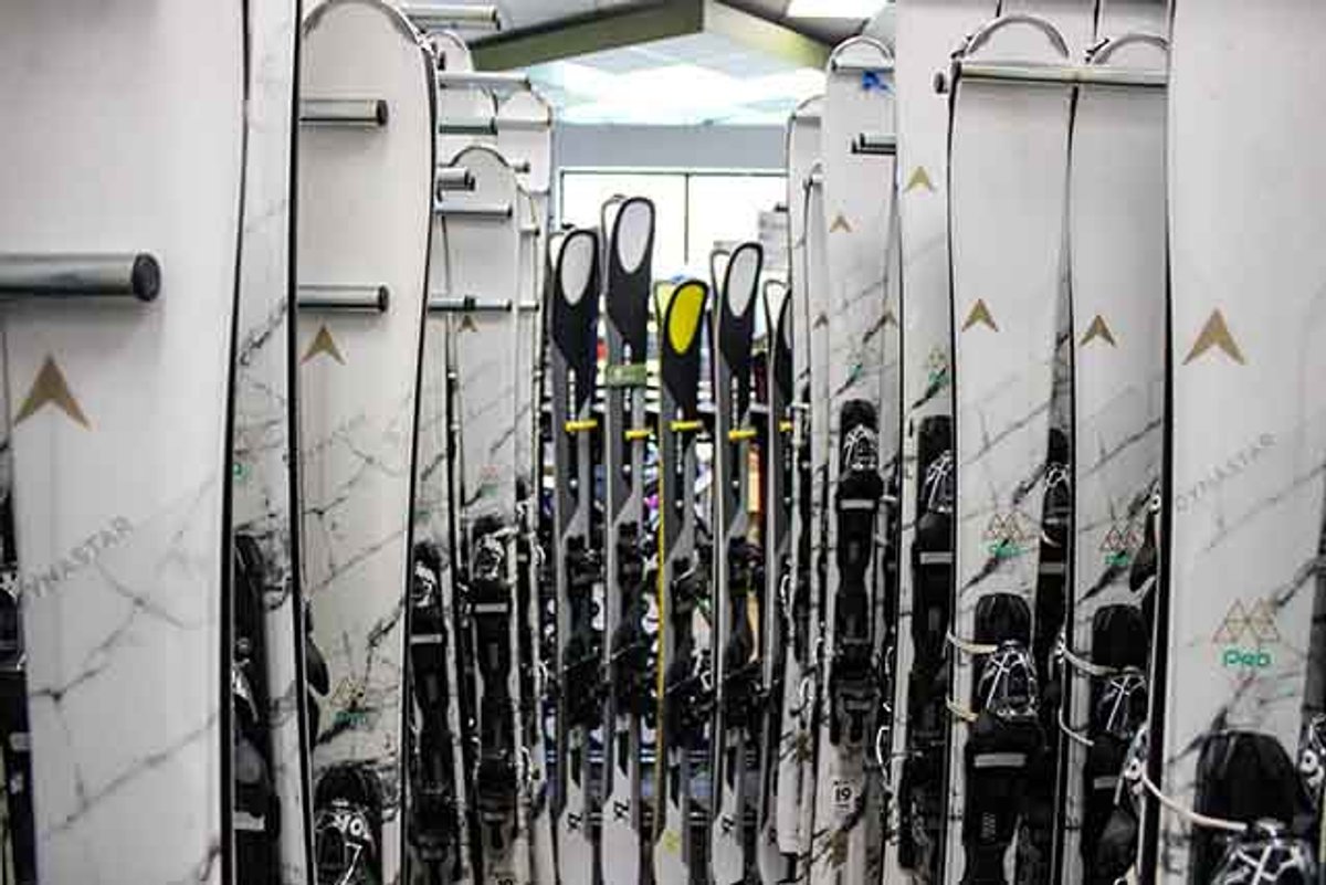 Ski Racks holding rental skis as well as a work shop in the distance.